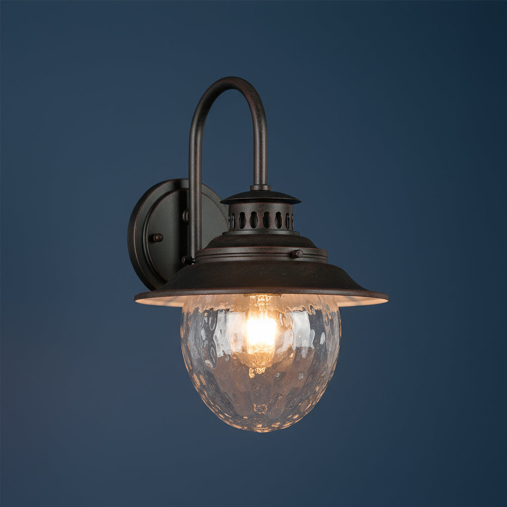 Antique Brass Outdoor Wall Light | Industrial Lantern-Style Sconce with Curved Arm and Hammered Glass Shade