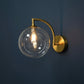 Modern Brass Wall Light | Curved Arm Sconce with Clear Glass Globe