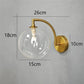 Modern Brass Wall Light | Curved Arm Sconce with Clear Glass Globe